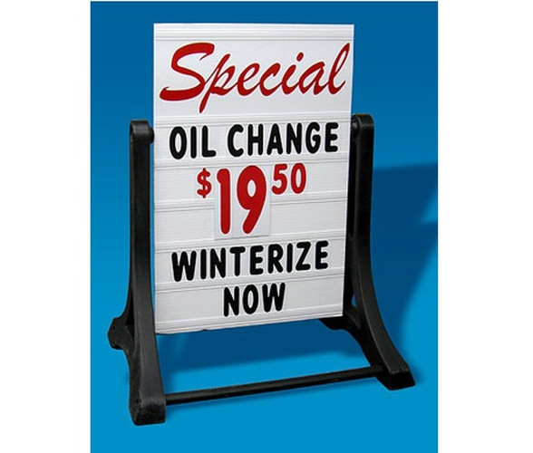 Deluxe Swinger sidewalk sign displaying an oil change special
