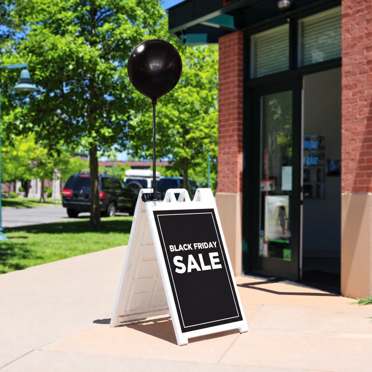 One black DuraBalloon mounted above a white Signicade with Black Friday SALE artwork
