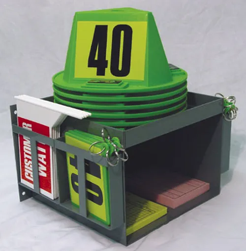 Wall-mount storage rack holding green magnetic car top hats, identification paddles and flags