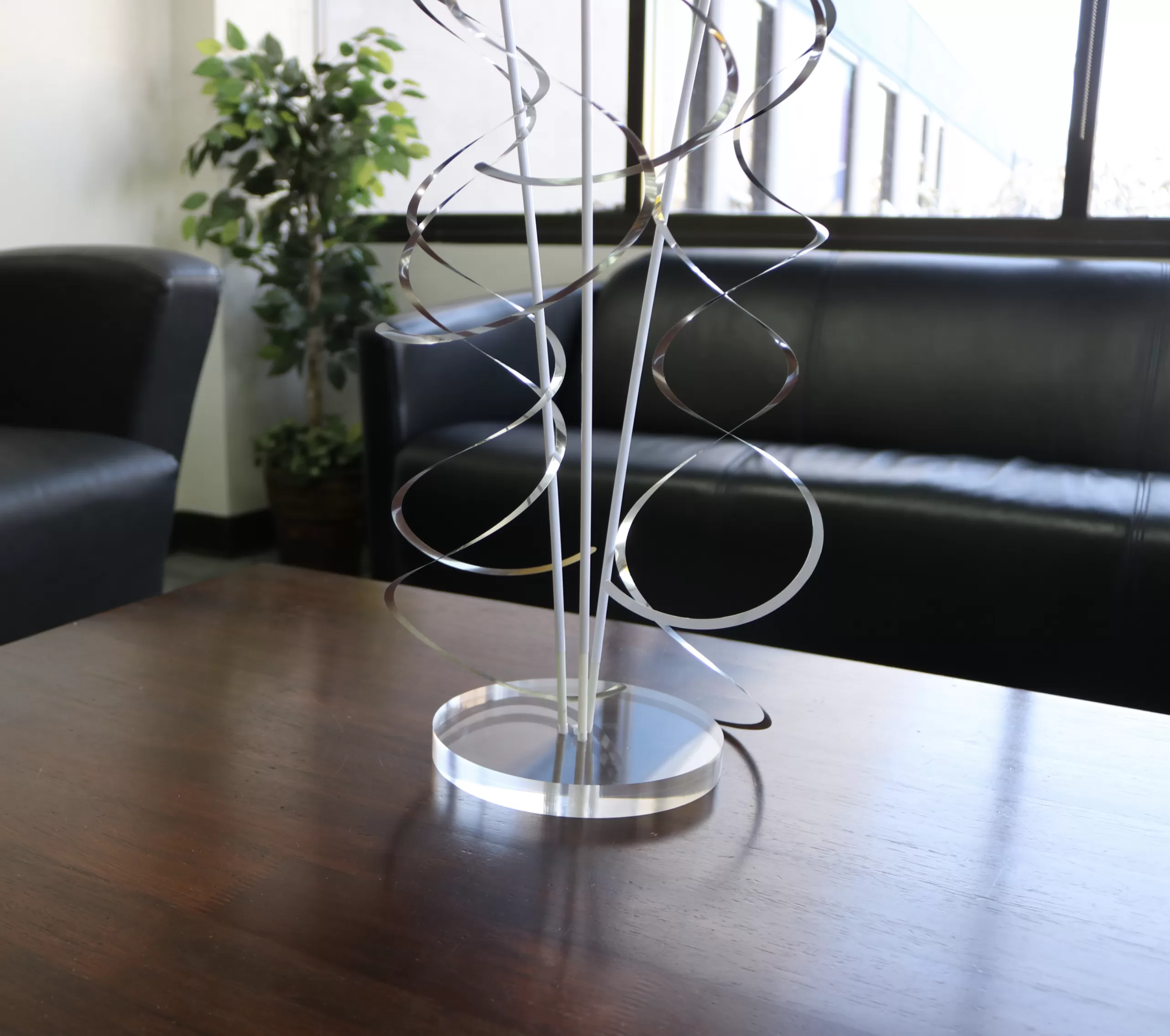 Clear round acrylic PermaShine weighted base shown supporting balloon stems
